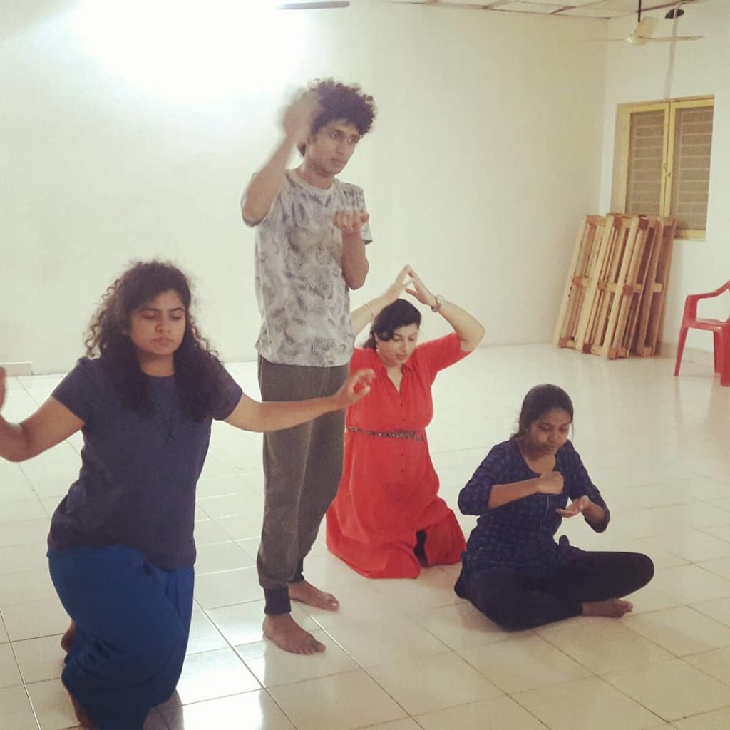 Participants rehearsing a scene in a studio