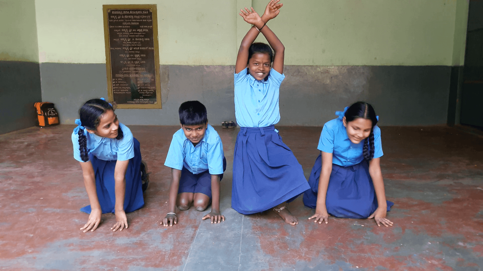 Children on a classroom floor during a theatre exercise